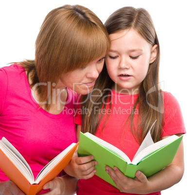 Mother and her daughter are reading books