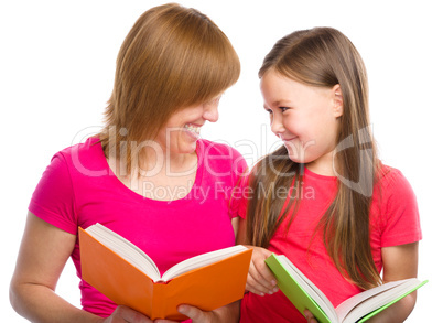 Mother and her daughter are reading books