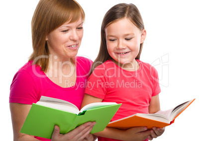 Mother and her daughter are reading books