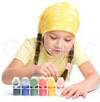 Cute thoughtful child play with paints