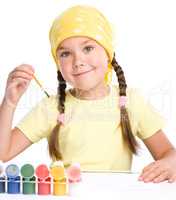 Cute cheerful child play with paints