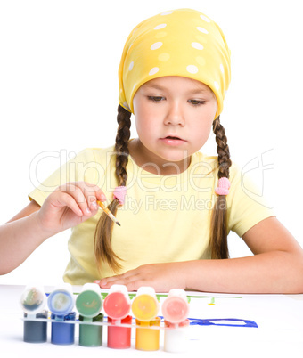 Cute thoughtful child play with paints