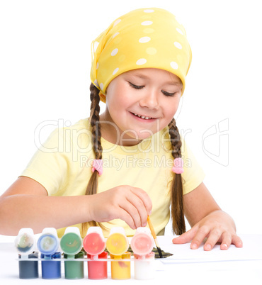 Cute cheerful child play with paints