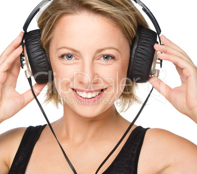 Young woman enjoying music using headphones