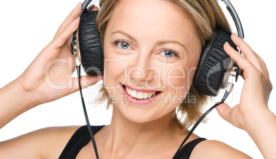 Young woman enjoying music using headphones