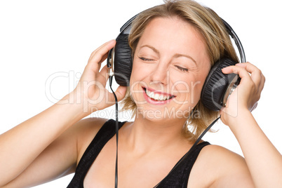 Young woman enjoying music using headphones