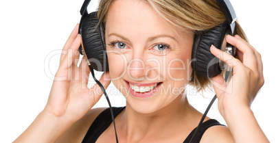 Young woman enjoying music using headphones