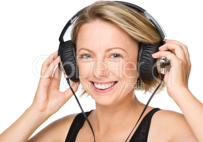 Young woman enjoying music using headphones