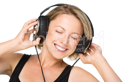 Young woman enjoying music using headphones