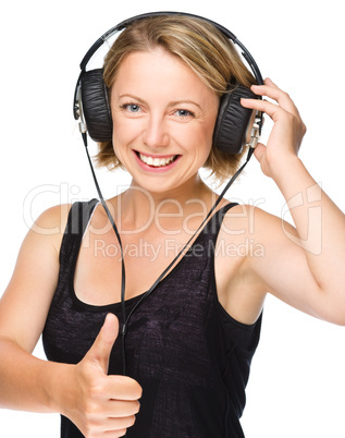 Young woman enjoying music using headphones