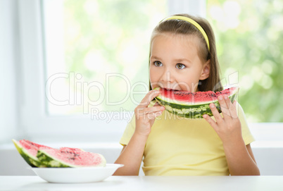 Cute little girl is eating watermelon