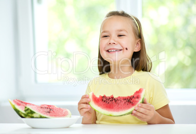 Cute little girl is eating watermelon