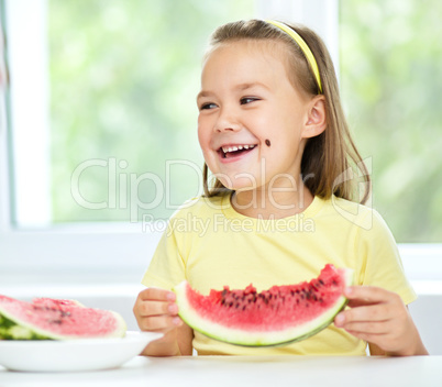 Cute little girl is eating watermelon