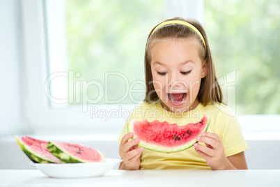 Cute little girl is eating watermelon