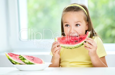 Cute little girl is eating watermelon