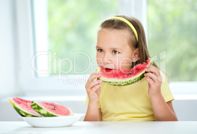 Cute little girl is eating watermelon