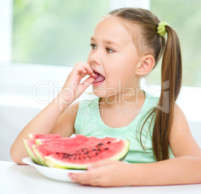 Cute little girl is eating watermelon