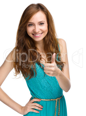 Woman is showing thumb up gesture