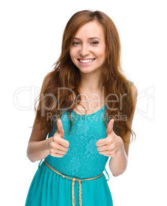 Woman is showing thumb up gesture