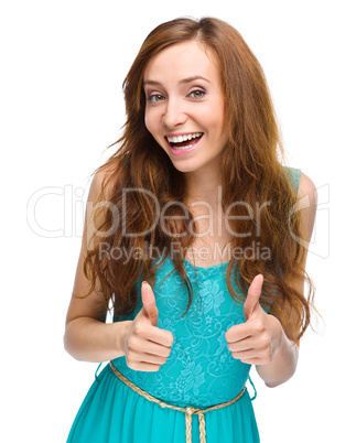 Woman is showing thumb up gesture