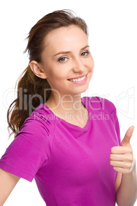 Woman is showing thumb up gesture