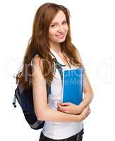 Young student girl is holding book