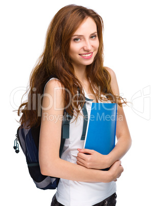 Young student girl is holding book