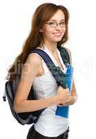 Young student girl is holding book