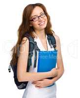 Young student girl is holding book