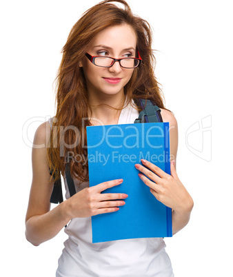 Young student girl is holding book