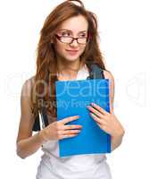 Young student girl is holding book