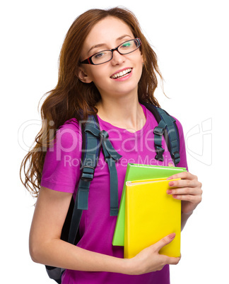 Young student girl is holding book