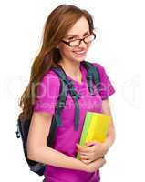 Young student girl is holding book