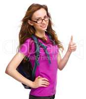 Young student girl is showing thumb up sign
