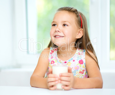 Cute little girl with a glass of milk