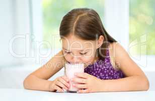 Cute little girl with a glass of milk