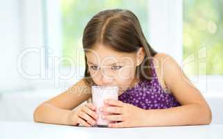 Cute little girl with a glass of milk