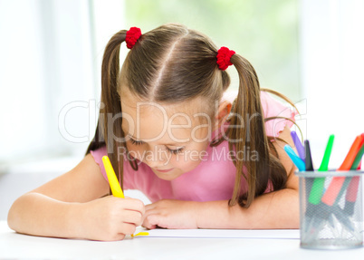 Cute cheerful child drawing using felt-tip pen