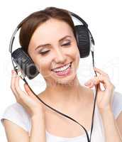 Young woman enjoying music using headphones