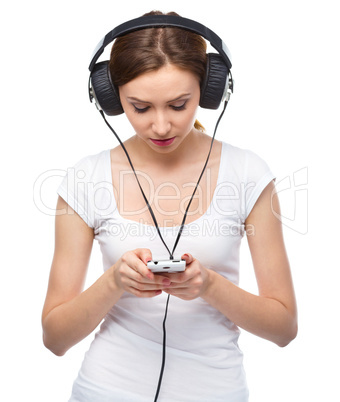 Young woman enjoying music using headphones