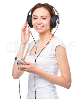 Young woman enjoying music using headphones