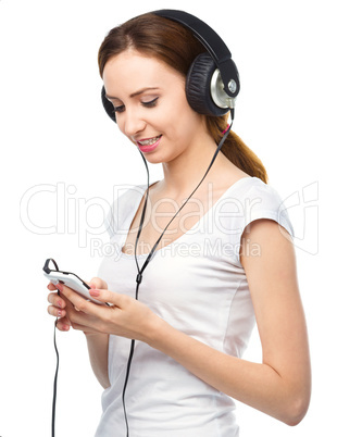 Young woman enjoying music using headphones