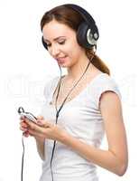 Young woman enjoying music using headphones