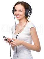 Young woman enjoying music using headphones