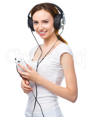 Young woman enjoying music using headphones