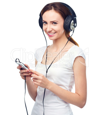 Young woman enjoying music using headphones