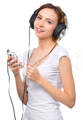 Young woman enjoying music using headphones