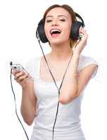 Young woman enjoying music using headphones