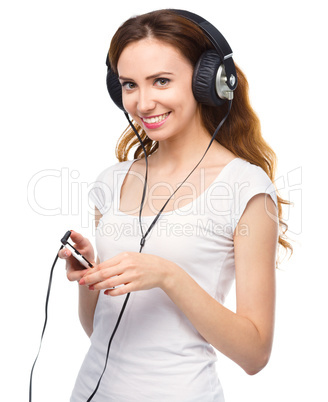 Young woman enjoying music using headphones