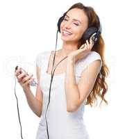 Young woman enjoying music using headphones